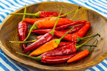 set red hot peppers mini pods on a wooden background