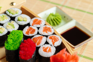 Set of maki sushi on wooden boat tray
