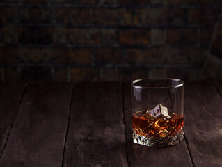 Whiskey drink on dark wooden table