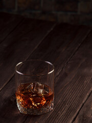 Whiskey drink on dark wooden table