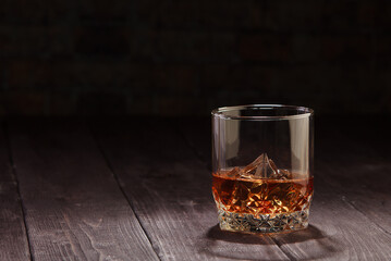 Whiskey drink on dark wooden table