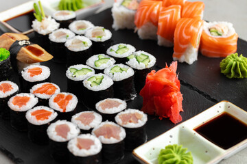 Maki sushi set served on black stone tray