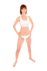 Fototapeta premium Full length portrait of a young athletic woman wearing a white bikini, isolated in front of white studio background