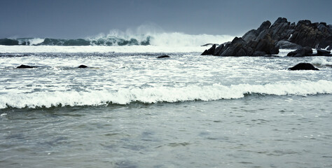 A sunny beach with palm trees on the Indian Ocean near the city of Galle in Sri Lanka.