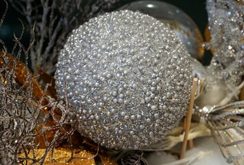 A silver studded ornament with beads for holiday decorations