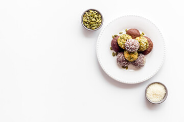 Vegen energy balls with pumpkin seeds and coconut, overhead view