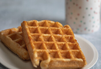 Close up of a homemade waffle over a table.