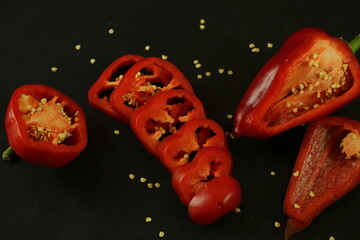 Red peppers on black background