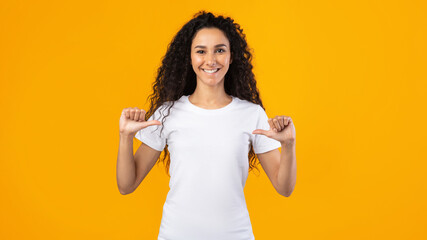 Happy Lady Pointing Thumbs At Herself Posing On Yellow Background