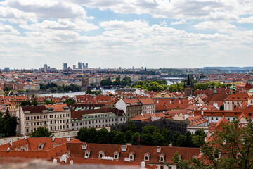Fototapeta na wymiar Prague city panorama. Orange and red roofs of the old city.