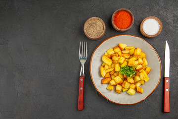 top view tasty fried potatoes inside plate with seasonings on dark background photo food oil color dinner bread