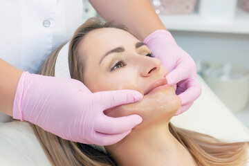 Cosmetological facial massage.