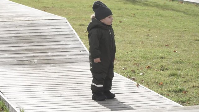 Boy running on wooden jumping platforms in city park
