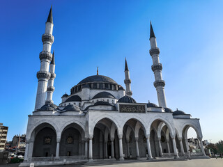 Fototapeta na wymiar Turkey, Ankara - October 23, 2019: New Melike Hatun Mosque with four minarets in Hergele Meydani quarter of Ankara. Beautiful Muslim religious building decorated with white marble - outside view