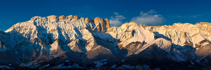 Panoramic Winter sunrise on the Faraut mountain peaks in the Champsaur Valley. Hautes-Alpes, European Alps, France
