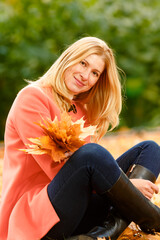 Woman in the autumn park. Girl on a background of fall. Autumn yellow and red leaves