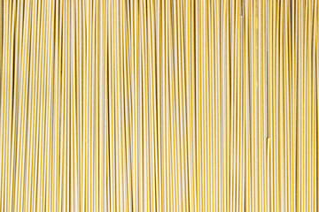 Uncooked thin spaghetti as the background, copyspace.