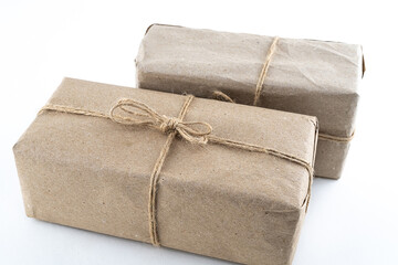 couple gift box in dark brown craft paper and jute ribbon on a white background