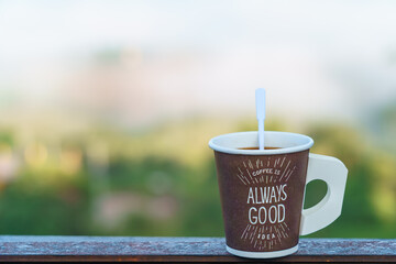 a paper cup of coffee with the word 