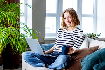 Business meeting online - young woman working on laptop at home