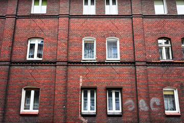 Windows in the brick facade of a historic house