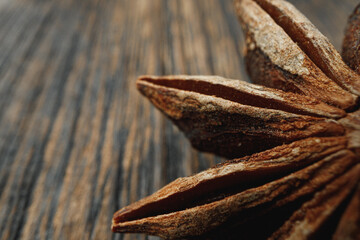 Macro photo of anise stars on wooden background