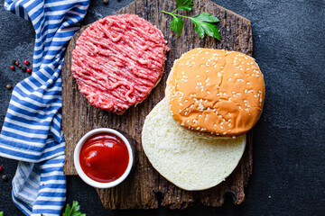 raw burger set cutlet meat, roll, sauce and more ready to eat on the table for making healthy meal snack top view copy space for text food background rustic