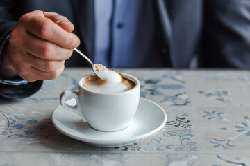 Close up of drinking cappuccino in a cafe.