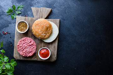 raw burger set cutlet meat, roll, sauce and more ready to eat on the table for making healthy meal snack top view copy space for text food background rustic