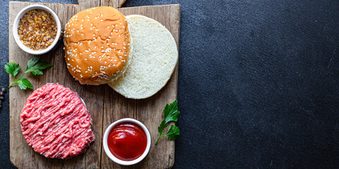 raw burger set cutlet meat, roll, sauce and more ready to eat on the table for making healthy meal snack top view copy space for text food background rustic