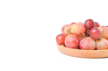Bunch of fresh grape on wooden plate isolated on a white background.
