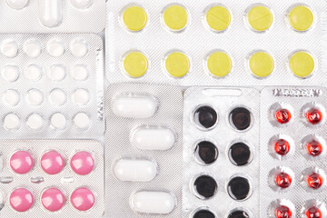 Different medicines tablets, pills in blister pack, medications drugs, macro close up in a white background