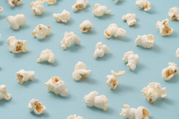 Isometric pattern with popcorn on pastel blue background. Minimal binge concept.