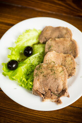 boiled beef tongue sliced in a plate
