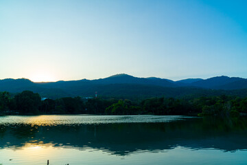 Ang Kaew lake at Chiang Mai University with forested mountain