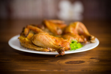 whole fried chicken in a plate on table