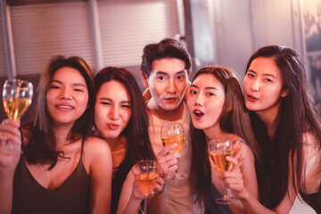 Group of people in party and celebrating together with white wine and beer.