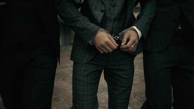 The police take the handcuffed prisoner to the prison. Detention of a suspect.