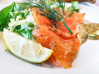 Grilled salmon and lemon - french cuisine dish with tomato and salmon