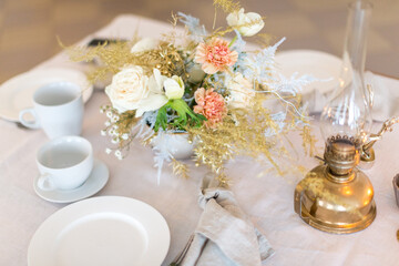 Christmas decoration of the festive table with cakes, glasses and candles