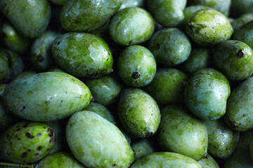 Close-up of heap of green fresh mango in Sri Lankan shop