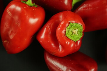 Red peppers on black background