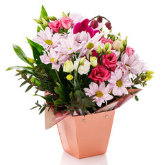 Pink gerberas, roses, eustoma and green leaves in a pink box on a white background.