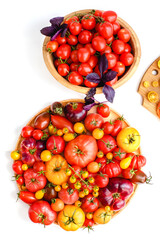 Different tomatoes on white. Vegetables of different varieties
