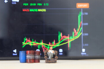 Simple Conceptual Photo, illustration for Senior Investor Mini Figure Toy businessman Seriously watching Running Stock Exchange Sitting at sofa beside Oil Barrel
