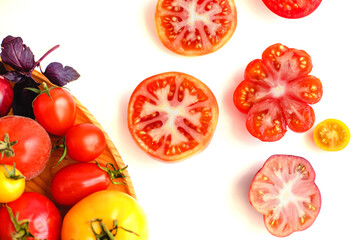 Fototapeta premium Different tomatoes on white. Vegetables of different varieties
