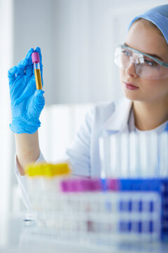 Laboratory assistant woman analyzing a blood sample