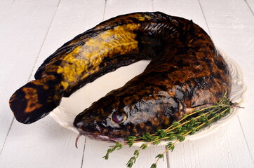 Fresh fish burbot on white plate, close up, white background