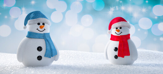 Two happy cute snowmen standing in winter landscape - greeting card with copy space - 3D...