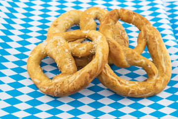 pretzel with salt oktoberfest symbol on bavaria flag background